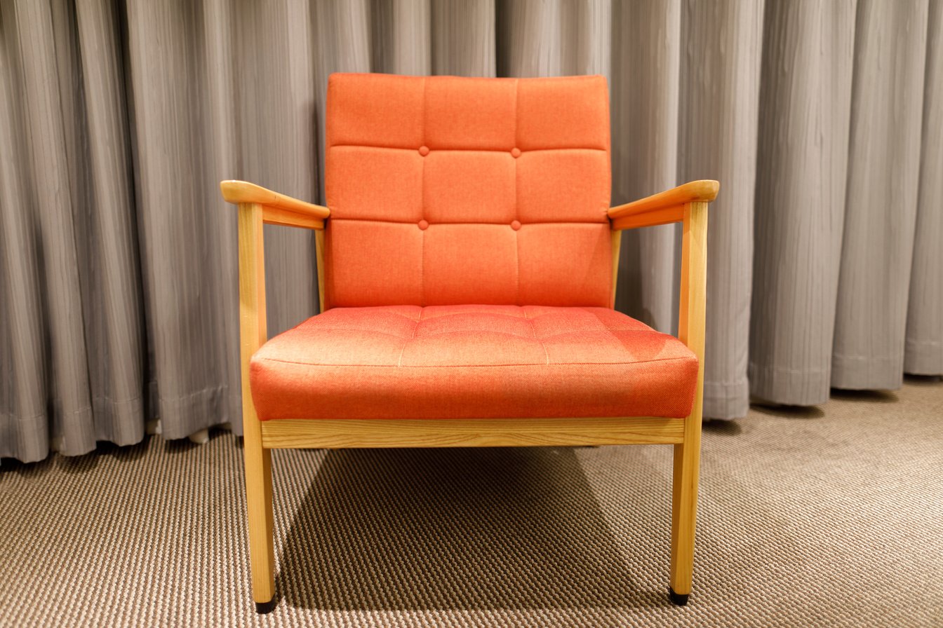 An orange sofa chair in the room