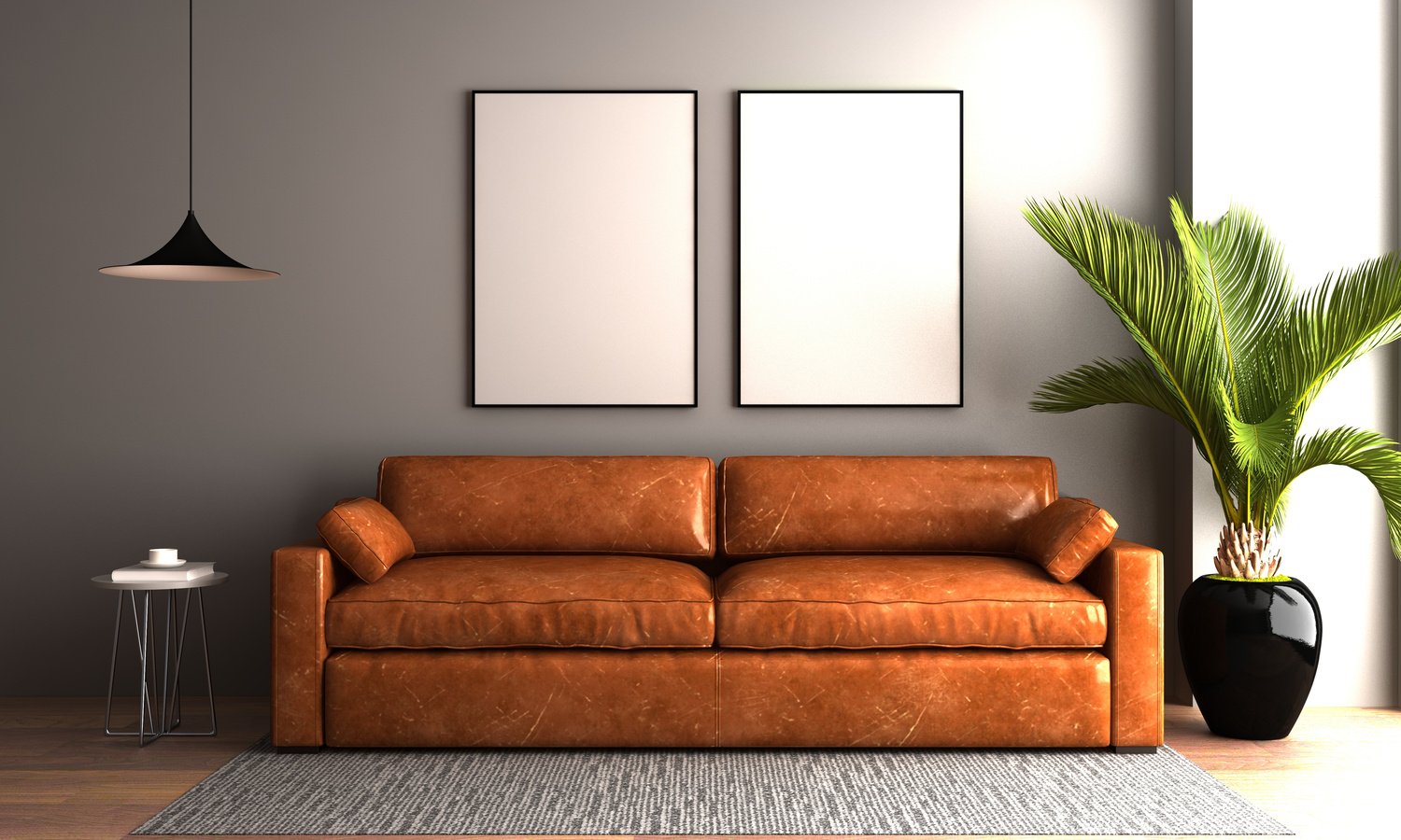 Brown Leather Couch with Blank Frames and a Plant