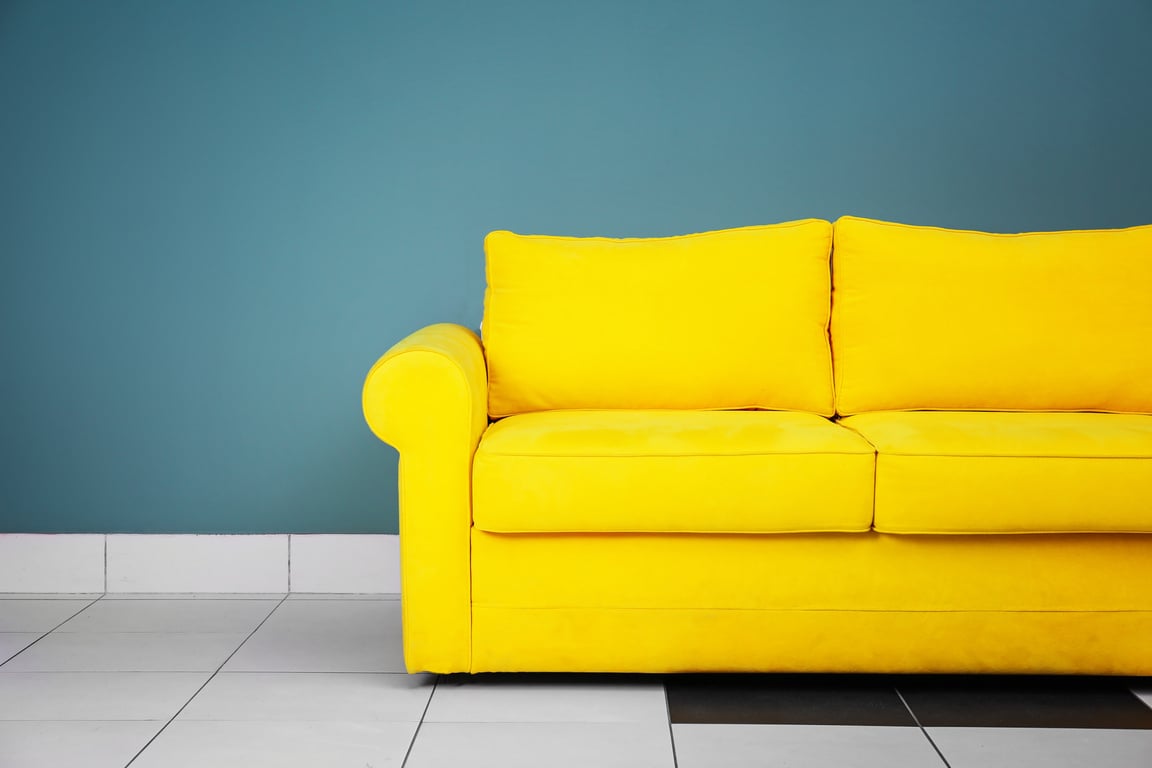 Comfortable Sofa on Color Wall Background