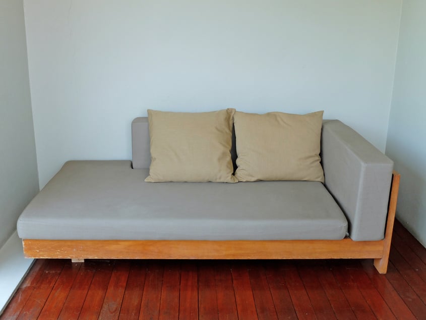 Gray Sofa Bed with Two Brown Pillows