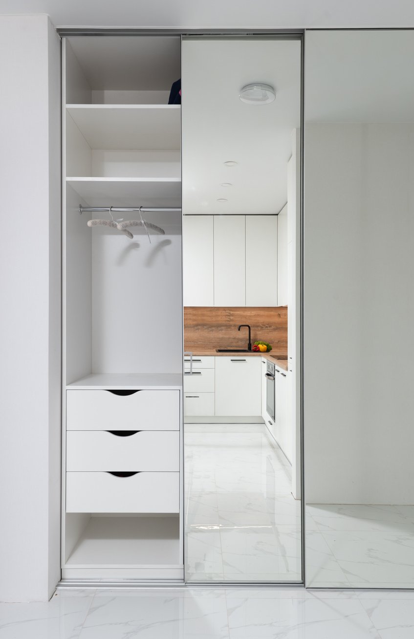 Wardrobe with mirrored door in contemporary apartment